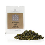 Huangjin Gui oolong tea packaging with loose tea leaves on a white background