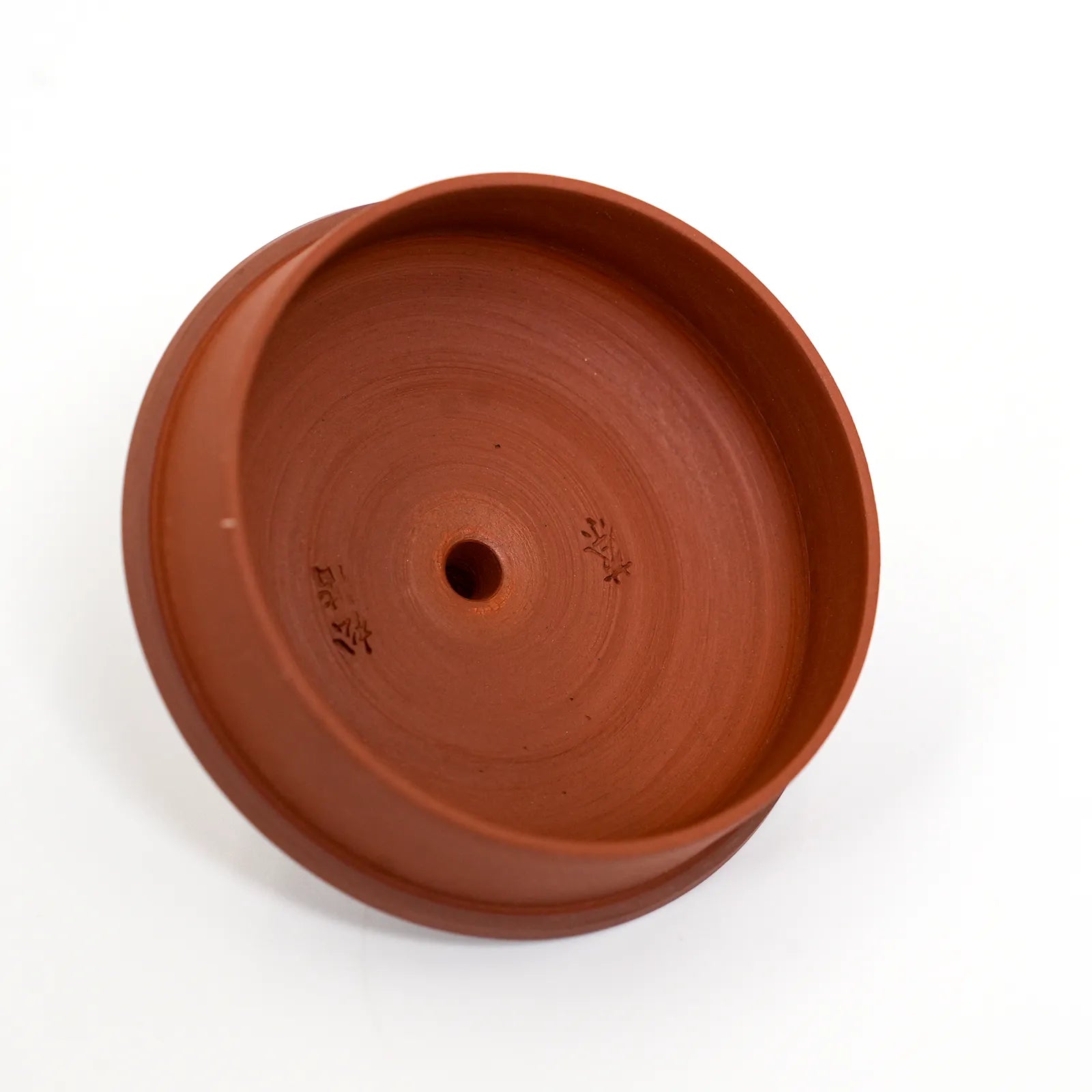 Terracotta pot on a white background