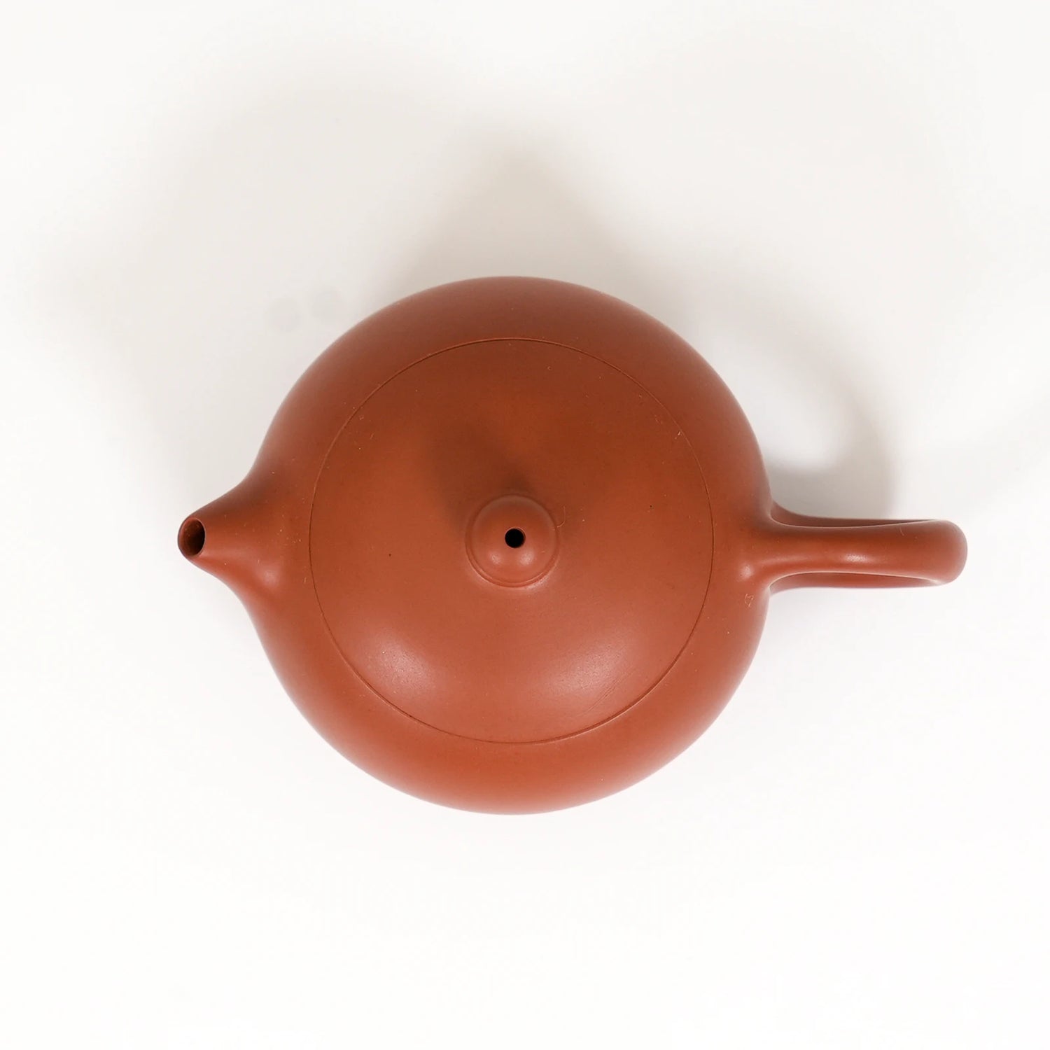 Red clay teapot on a white background