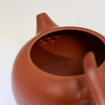 Close-up of a terracotta teapot on a white background